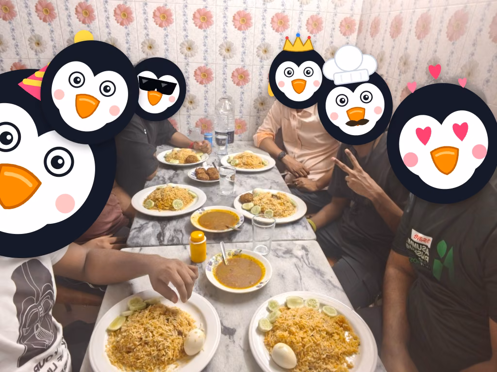 The Penguins Club members gathered around table sharing meals and open source discussions