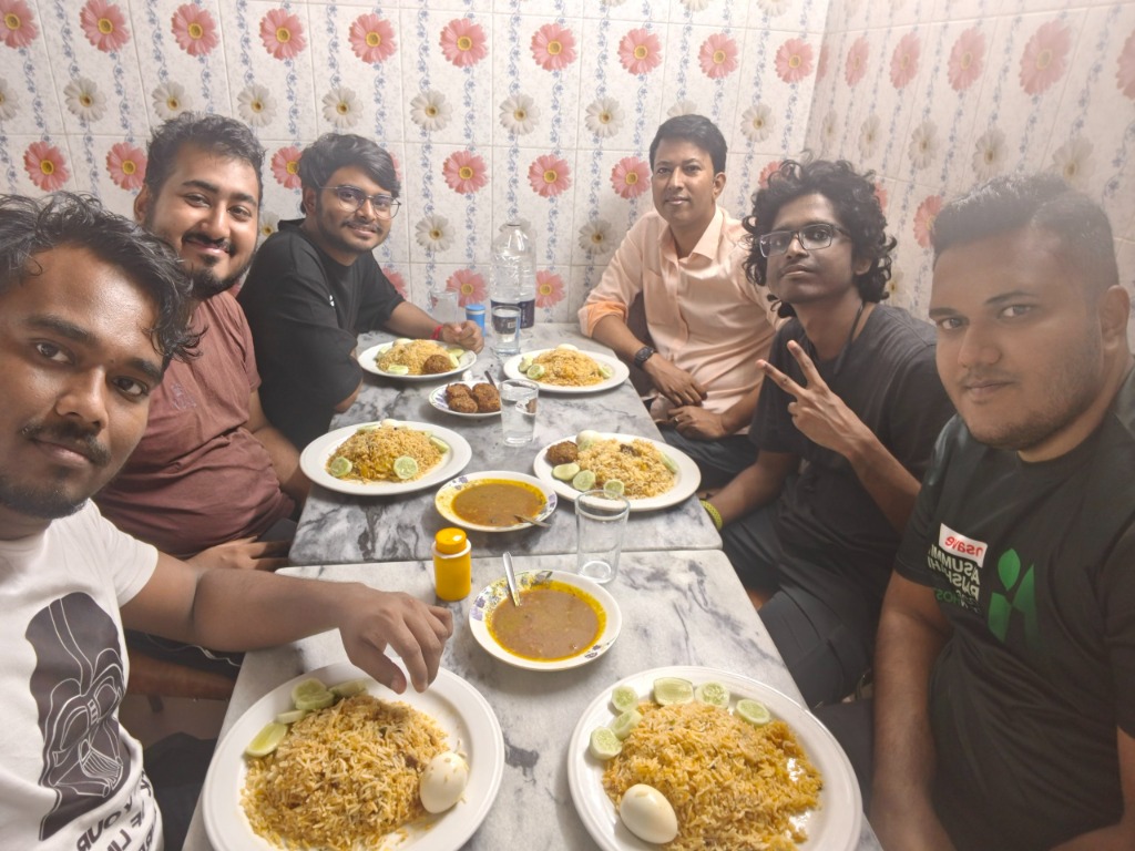 The Penguins Club members gathered around table sharing meals and open source discussions